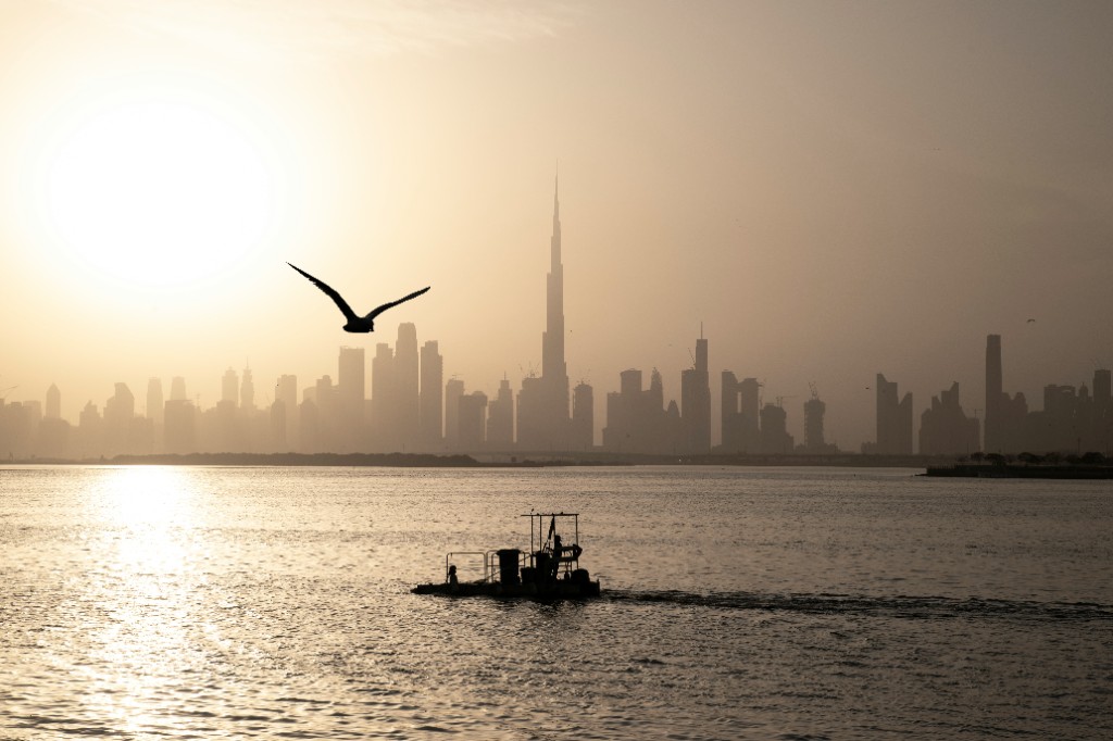 Dubai skyline at sunset across the water